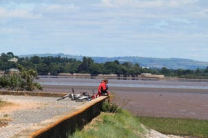 Exe Estuary Cycle Train With Cyclists Sat On Ledge