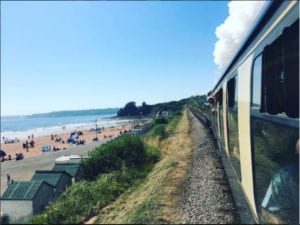 Dartmouth Steam Railway Passing Beach And Sea