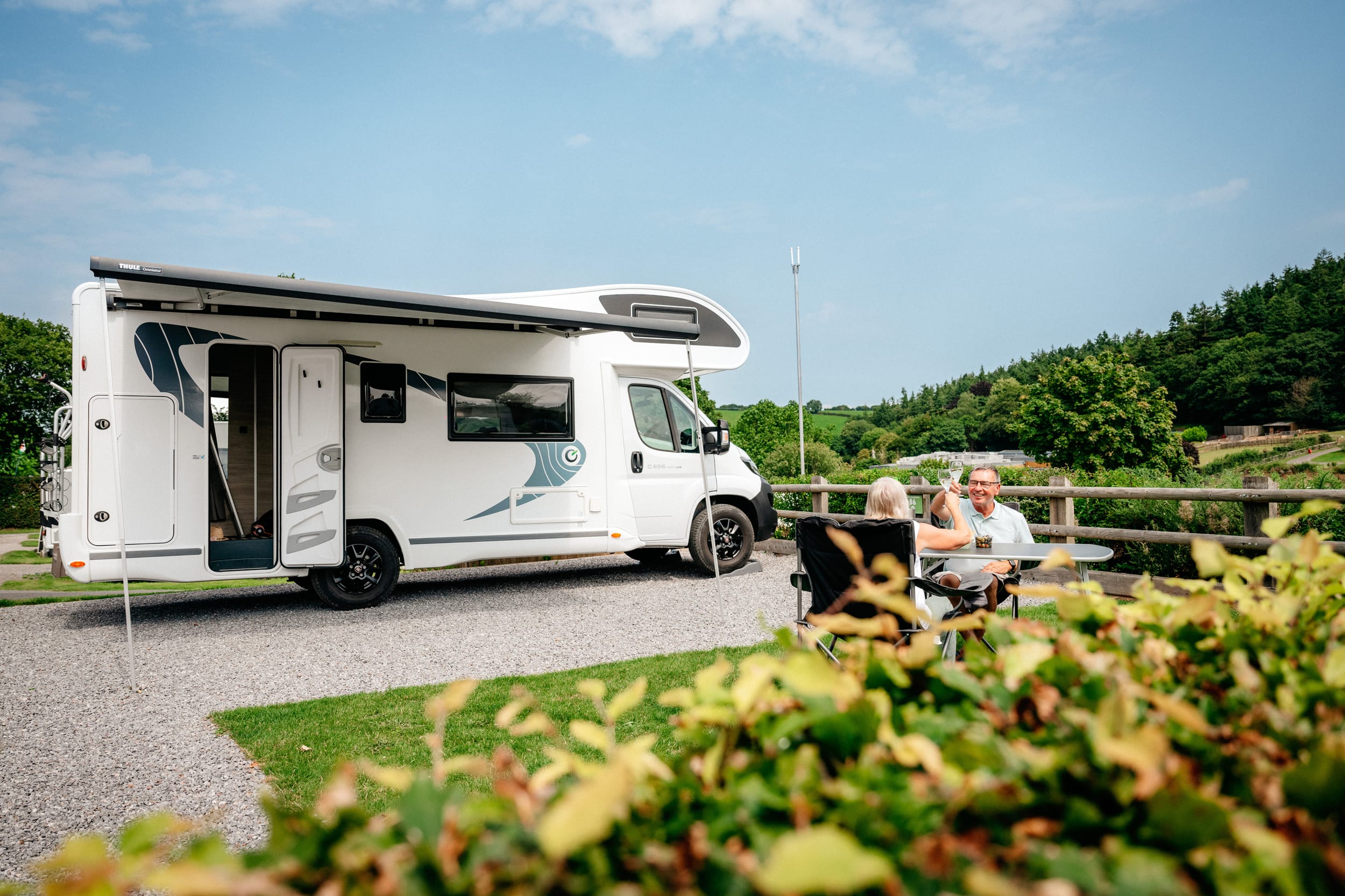 Spring-Touring-Breaks A coulpe sat outside their motorhome on a spring touring break