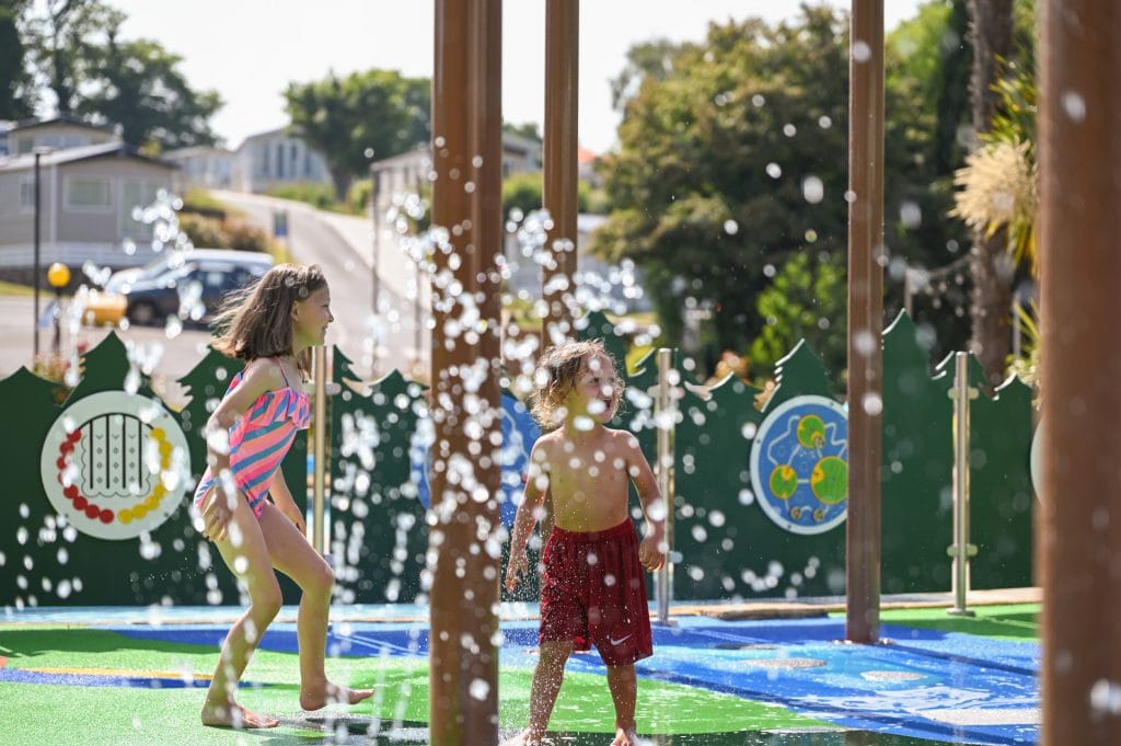 Kids playing at the splashpad at Cofton Holidays