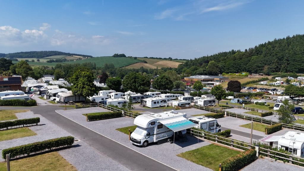Aerial view of Cofton's touring pitches with a backdrop of green Devon countryside